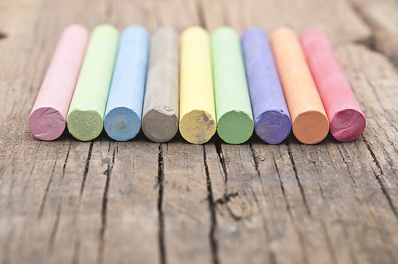 colorful chalks on old wooden table